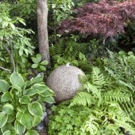 granite sphere fountain, ferns, hostas