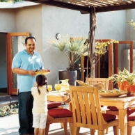 man and small girl eating at outdoor table