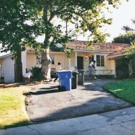 outdated house with sloped front yard before gardening remodel