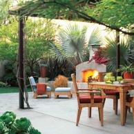 outdoor living space with fireplace, patio dining set and lounge chair