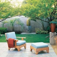 outdoor patio with lounge chair and small patch of grass