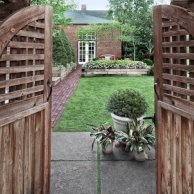 pots hold clipped boxwood and Calathea triostar at yard entry