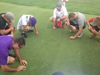 students inspecting turf